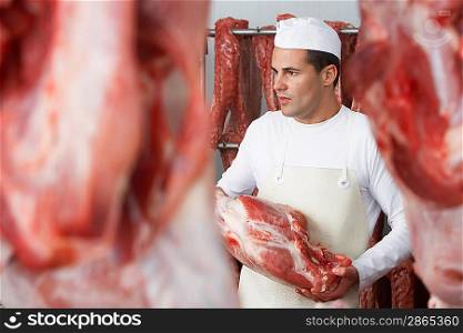 Butcher Standing in Meat Locker