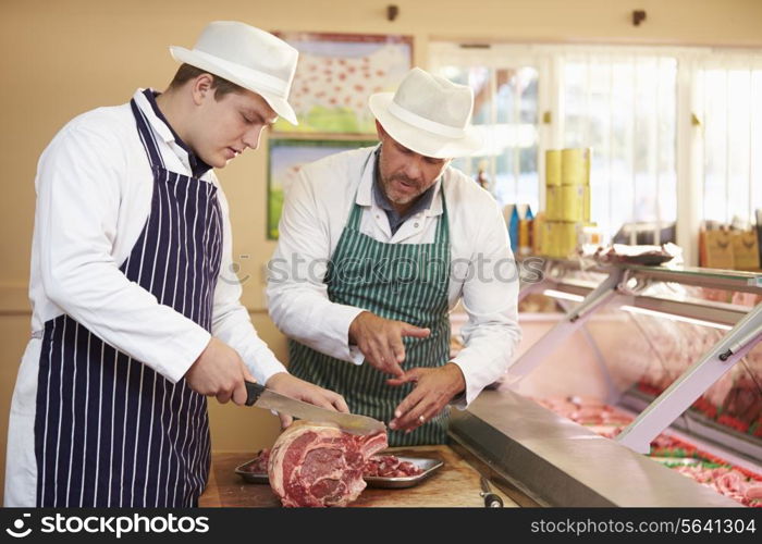 Butcher Teaching Apprentice How To Prepare Meat