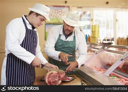 Butcher Teaching Apprentice How To Prepare Meat
