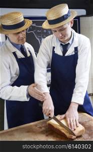 Butcher Teaching Apprentice How To Prepare Sirloin Steak