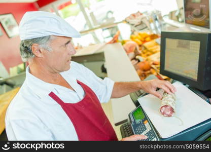 Butcher weighing some meat