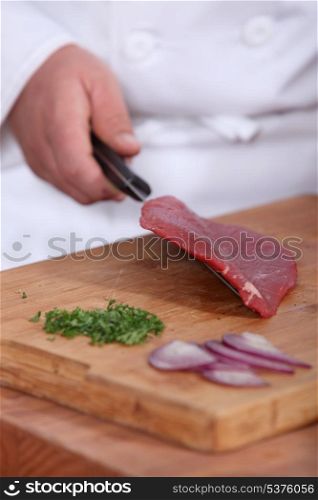 Butcher with raw piece of piece