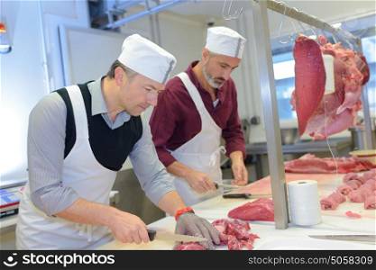 Butchers dicing meat