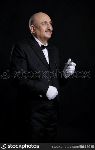 Butler holding a pocket watch