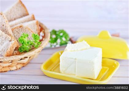butter and bread on the wooden table