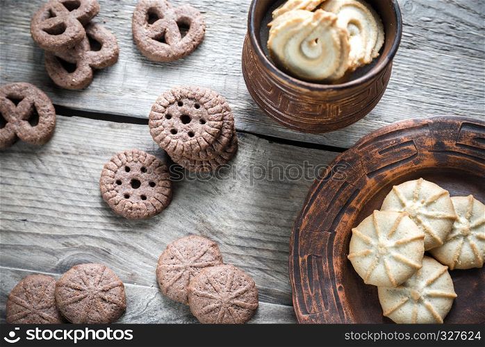 Butter and chocolate chip cookies on the wooden background