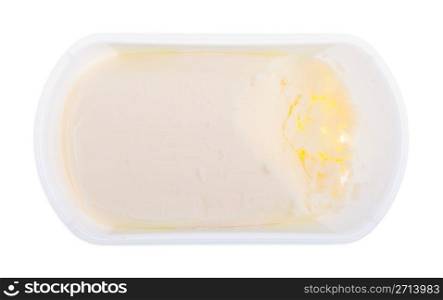 butter close-up on a plastic tub isolated on white background