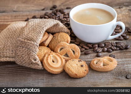 Butter cookies in burlap bag with a cup of coffee