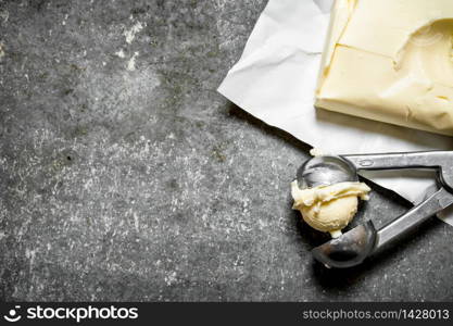 Butter in a special scissors. On the stone table.. Butter in a special scissors.