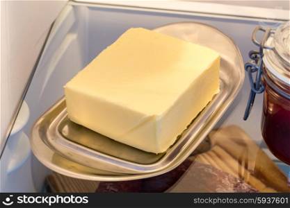 Butter in the fridge with the door open. Butter in the fridge with the door open.
