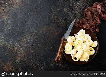 butter on black plate on a table