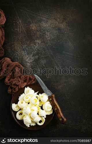 butter on black plate on a table