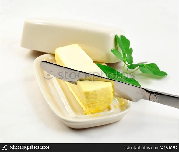 butter on white butterdish and knife