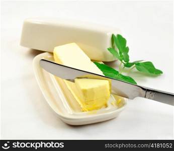 butter on white butterdish and knife