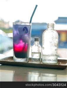 Butterfly pea ice cube server with soda water. Butterfly pea ice cube