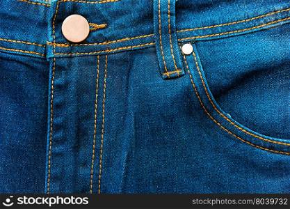 button and front pocket of jeans close-up
