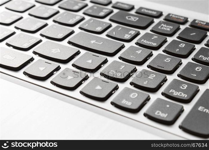 Button of laptop or notebook in close up right view. Office supply concept