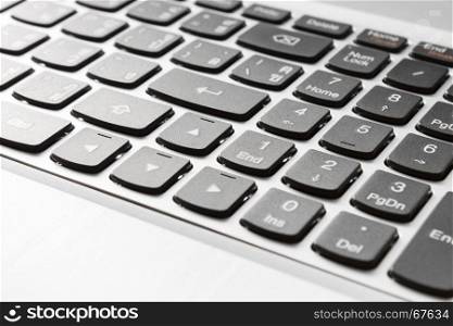 Button of laptop or notebook in close up right view. Office supply concept