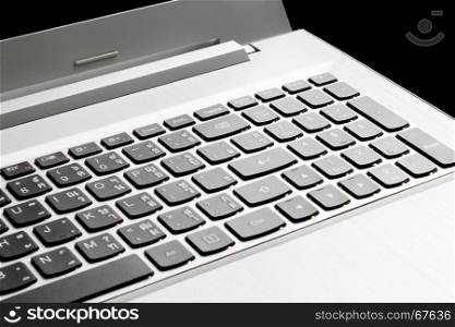 Button of laptop or notebook on black background in dramatic mood