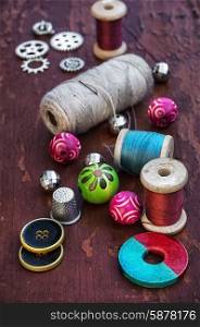 Buttons and thread. set of threads and buttons on old wooden background