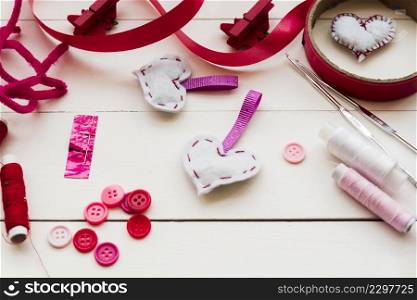 buttons crochet needles thread reels ribbons sewing heart shape from fabric wooden table