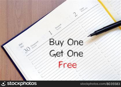 Buy one get one free text concept write on notebook