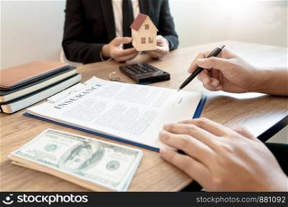buy or sell real estate concept, Sale representative offer house purchase contract to buy a house or apartment and give home key chain to customer
