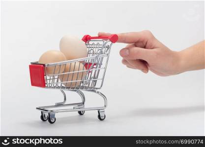 Buyer&rsquo;s hand pushes a chicken cart with a finger