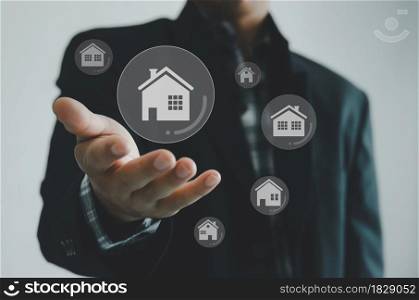 Buying, selling and renting houses or real estate concept, property online, Businessman hands on a virtual screen concept.