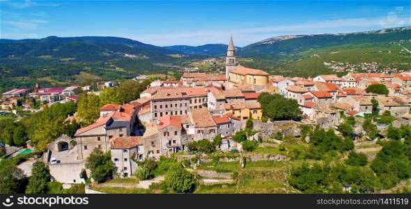 Buzet. Hill town of Buzet surrounded by stone walls in green landscape aerial panoramic view. Istria region of Croatia.