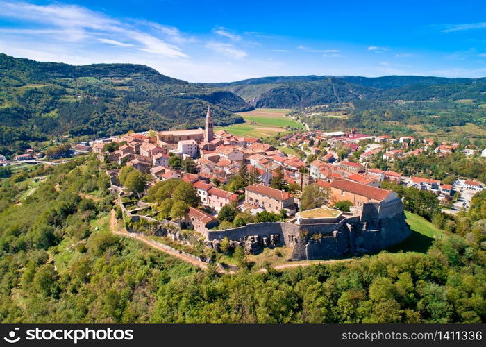 Buzet. Hill town of Buzet surrounded by stone walls in green landscape aerial view. Istria region of Croatia.