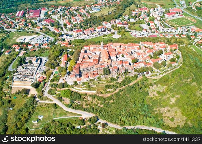 Buzet. Hill town of Buzet surrounded by stone walls in green landscape aerial view. Istria region of Croatia.