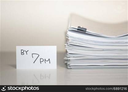 By 7 PM; Stack of Documents on white desk and Background.
