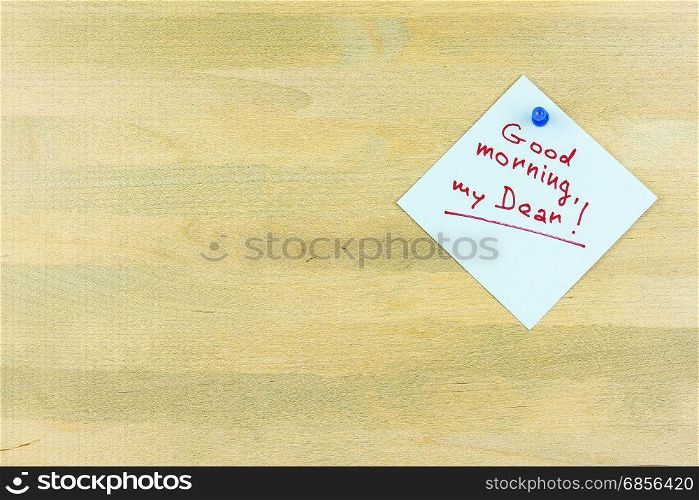 "By the wooden surface is attached a sheet of plain button with the words "Good morning, my dear""