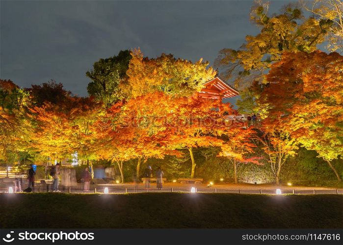 Byodoin Temple Pagoda and lake with red maple leaves or fall foliage in autumn season. Colorful trees, Kyoto, Japan. Nature and architecture landscape background.