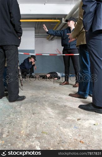 Bystanders looking at a crime scene with a murdered woman