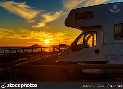 C&er vehicle at sunset on mediterranean coast in Spain. Cala Magre in Calblanque Regional Park, Murcia region. Vacation and traveling in motorhome.. Caravan on coast at sunset