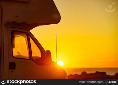 C&er vehicle c&ing on beach sea shore at sunrise. Adventure, travel with motor home.. Caravan on beach at sunrise