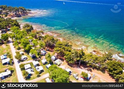 C&ing by the sea and crystal clear stone beach aerial view in Savudrija, Istria region of Croatia 