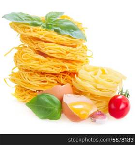 c raw pasta with egg and tomato isolated on white background. Tonarelli and tagliatelle raw pasta