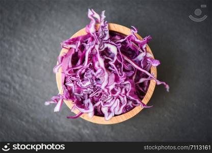 Cabbage purple / Shredded red cabbage slice in a wooden bowl and dark background , top view