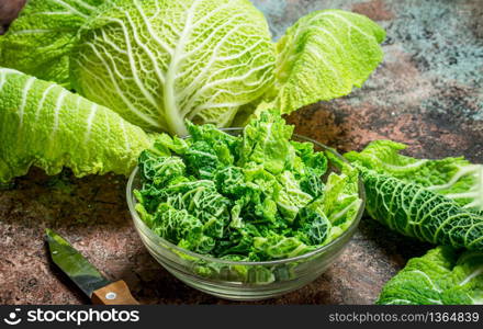 Cabbage salad in a glass bowl. On rustic background.. Cabbage salad in a glass bowl.