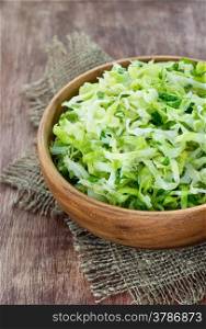 Cabbage salad in wooden bowl, selective focus