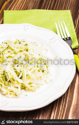 Cabbage salad - shredded fresh cabbage with dill on a plate