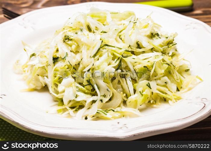 Cabbage salad - shredded fresh cabbage with dill on a plate