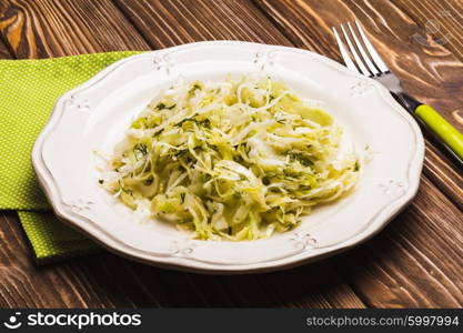 Cabbage salad - shredded fresh cabbage with dill on a plate. The Cabbage salad