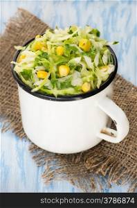 Cabbage salad with corn in vintage cup, selective focus