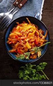 Cabbage stew with carrot in tomato sauce - traditional dish of Russian cuisine
