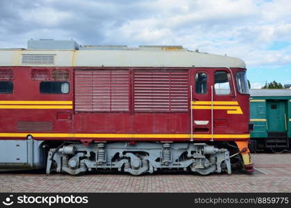 Cabin of modern Russian electric train. Side view of the head of railway train with a lot of wheels and windows in the form of portholes