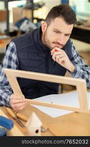 cabinet-maker building a wooden frame